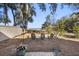 Secluded backyard with Adirondack chairs and natural surroundings for peaceful outdoor enjoyment at 161 Marsh Hawk Ln, Kiawah Island, SC 29455
