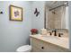 Stylish powder room with a marble countertop and decorative butterfly wall decor at 161 Marsh Hawk Ln, Kiawah Island, SC 29455