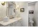 Bathroom vanity with stylish fixtures, decorative mirror, and adjacent toilet at 161 Marsh Hawk Ln, Kiawah Island, SC 29455