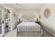 Bright bedroom with walk-out patio doors and stylish lamps flanking the bed at 161 Marsh Hawk Ln, Kiawah Island, SC 29455