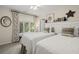 Bright bedroom with twin beds, stylish decor, and ample natural light from the window at 161 Marsh Hawk Ln, Kiawah Island, SC 29455