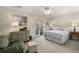Comfortable bedroom with a decorative dresser, arm chair, and walk-out patio at 161 Marsh Hawk Ln, Kiawah Island, SC 29455