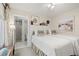 Well-lit bedroom with access to an en-suite bathroom and tasteful wall decor at 161 Marsh Hawk Ln, Kiawah Island, SC 29455