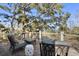Inviting deck with outdoor seating and scenic views of lush foliage and waterfront at 161 Marsh Hawk Ln, Kiawah Island, SC 29455