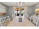 Dining area boasting an elegant chandelier and access to a scenic outdoor patio with water views at 161 Marsh Hawk Ln, Kiawah Island, SC 29455