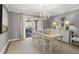 Elegant dining room with chandelier, stylish chairs, and sliding doors to the outdoor patio at 161 Marsh Hawk Ln, Kiawah Island, SC 29455