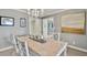 Bright dining room with gray wallpaper, chandelier, and unique artwork at 161 Marsh Hawk Ln, Kiawah Island, SC 29455
