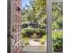 Inviting entryway with an open door, a view of the outdoor patio, and well-kept landscaping at 161 Marsh Hawk Ln, Kiawah Island, SC 29455