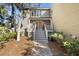 Charming home featuring a welcoming front porch with a brick walkway and garden at 161 Marsh Hawk Ln, Kiawah Island, SC 29455
