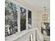 Hallway with large windows offering natural light and outdoor views at 161 Marsh Hawk Ln, Kiawah Island, SC 29455
