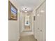 Inviting hallway with neutral carpet, soft white walls, and a beautiful mirror at 161 Marsh Hawk Ln, Kiawah Island, SC 29455