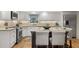 Well-lit kitchen with granite counters, white cabinetry, and stainless steel appliances at 161 Marsh Hawk Ln, Kiawah Island, SC 29455