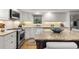 Bright kitchen with granite counters, tiled backsplash, and stainless steel appliances at 161 Marsh Hawk Ln, Kiawah Island, SC 29455