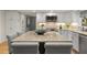 Open kitchen with granite countertops, island with seating, and stainless steel appliances at 161 Marsh Hawk Ln, Kiawah Island, SC 29455