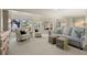 Bright living room featuring large windows and a comfortable seating arrangement with beautiful water views at 161 Marsh Hawk Ln, Kiawah Island, SC 29455