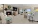 Cozy living room with a stone fireplace, lake views, and comfortable seating at 161 Marsh Hawk Ln, Kiawah Island, SC 29455
