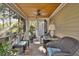 Cozy screened-in porch with comfortable seating and wooded views at 161 Marsh Hawk Ln, Kiawah Island, SC 29455