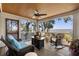 Relaxing screened porch with comfortable seating, an outdoor fireplace, and picturesque views of the waterway at 161 Marsh Hawk Ln, Kiawah Island, SC 29455