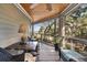 Relaxing screened-in porch featuring wood ceiling, water view, and wicker seating at 161 Marsh Hawk Ln, Kiawah Island, SC 29455