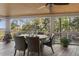 Inviting screened porch with a dining table, comfortable seating, and scenic views, ideal for outdoor gatherings at 161 Marsh Hawk Ln, Kiawah Island, SC 29455