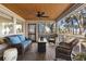 Cozy screened-in porch with outdoor seating, ceiling fan, and wooded views at 161 Marsh Hawk Ln, Kiawah Island, SC 29455