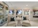 Inviting sitting area with water views, cozy chairs, and natural light filtering through multiple windows at 161 Marsh Hawk Ln, Kiawah Island, SC 29455