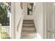 Bright staircase with neutral carpeting and white trim leading to upper level at 161 Marsh Hawk Ln, Kiawah Island, SC 29455