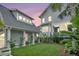 Charming backyard with lush green grass, tropical landscaping, and well-maintained exterior of the light blue home at 164 River Green Pl, Charleston, SC 29492
