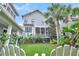 Charming backyard featuring a green lawn with beautiful landscaping and a light gray house at 164 River Green Pl, Charleston, SC 29492
