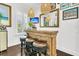 Charming bar area featuring a wooden counter, stylish stools, and tropical decor, perfect for entertaining guests in a relaxed setting at 164 River Green Pl, Charleston, SC 29492