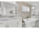 This bathroom has double sinks, marble countertops, and decorative wallpaper at 164 River Green Pl, Charleston, SC 29492