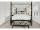 The bedroom features a four poster bed, white walls, and many windows at 164 River Green Pl, Charleston, SC 29492