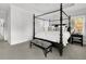 A bedroom features a four poster bed with a zebra print bench and white walls at 164 River Green Pl, Charleston, SC 29492