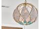 Close up of an elegant and unique beaded chandelier that adds a touch of coastal charm to the home's decor at 164 River Green Pl, Charleston, SC 29492