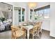 Dining room features a table setting, woven chairs, chandelier, and a patio doorway at 164 River Green Pl, Charleston, SC 29492