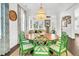 Elegant dining room with a round table, green chairs, stylish decor, and a chandelier, creating a perfect setting for memorable meals at 164 River Green Pl, Charleston, SC 29492