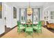 Elegant dining room with a round table, green chairs, stylish decor, and a chandelier, creating a perfect space for gatherings at 164 River Green Pl, Charleston, SC 29492