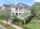 Stunning two-story light blue home with double balconies, lush landscaping, and a well-manicured front yard at 164 River Green Pl, Charleston, SC 29492