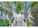 Charming home entrance framed by palm trees and lush greenery, creating a welcoming curb appeal at 164 River Green Pl, Charleston, SC 29492