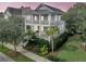 Stunning two-story coastal home featuring double balconies surrounded by lush tropical landscaping at 164 River Green Pl, Charleston, SC 29492