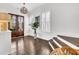 Inviting foyer featuring hardwood floors, plantation shutters, stylish lighting, and a welcoming ambiance at 164 River Green Pl, Charleston, SC 29492