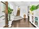 Elegant foyer with hardwood floors, a staircase, decorative mirror, and stylish console table creating a welcoming entrance at 164 River Green Pl, Charleston, SC 29492