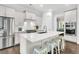 Modern kitchen features an island with seating, stainless steel appliances, and sleek white cabinetry at 164 River Green Pl, Charleston, SC 29492