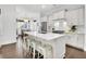 Spacious kitchen boasts a large island, modern lighting, stainless fridge, and bar stool seating at 164 River Green Pl, Charleston, SC 29492