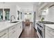 This kitchen features stainless appliances, subway tile backsplash, white cabinets, and bar stool seating at 164 River Green Pl, Charleston, SC 29492