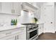 Gourmet kitchen with stainless steel appliances, white cabinetry, and stylish subway tile backsplash at 164 River Green Pl, Charleston, SC 29492