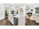 Bright, open kitchen and living area featuring a large island, stainless appliances, and a cozy fireplace at 164 River Green Pl, Charleston, SC 29492