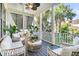 Inviting porch offers a comfortable seating area and views of lush tropical landscaping at 164 River Green Pl, Charleston, SC 29492