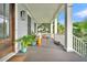 Relaxing porch with comfortable seating, unique decor, and an inviting outdoor living space overlooking lush greenery at 164 River Green Pl, Charleston, SC 29492