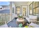 Comfortable porch features cozy seating, ceiling fan, and serene neighborhood views at 164 River Green Pl, Charleston, SC 29492